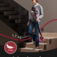 Woman carrying a lightweight vacuum cleaner up stairs with text 'Just 1.7kg' 